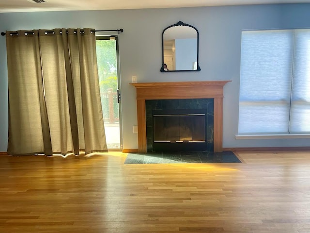 728 Woodland Estates Dr, Baldwin, NY 11510 - unfurnished living room with wood finished floors and a fireplace