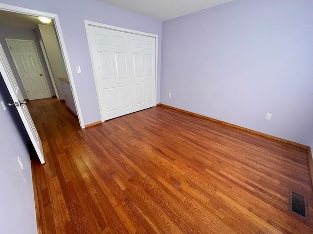 728 Woodland Estates Dr, Baldwin, NY 11510 - unfurnished bedroom featuring wood finished floors and a closet