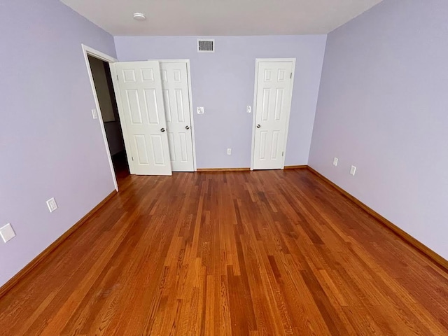 728 Woodland Estates Dr, Baldwin, NY 11510 - unfurnished bedroom featuring baseboards and wood finished floors