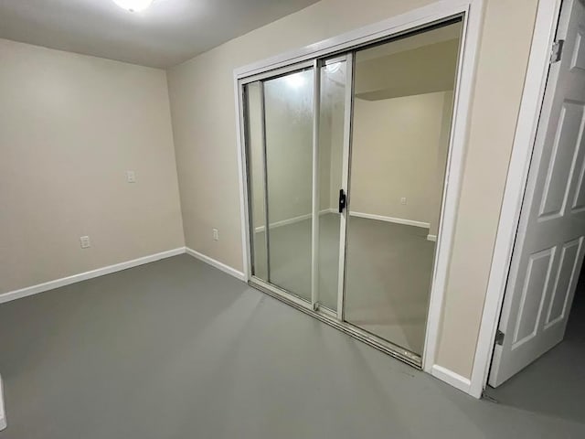 728 Woodland Estates Dr, Baldwin, NY 11510 - unfurnished bedroom featuring a closet and concrete flooring