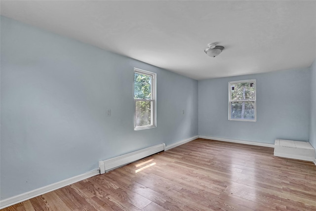 104 Schmidt Ave, Holbrook, NY 11741 - unfurnished room with a baseboard heating unit and wood finished floors