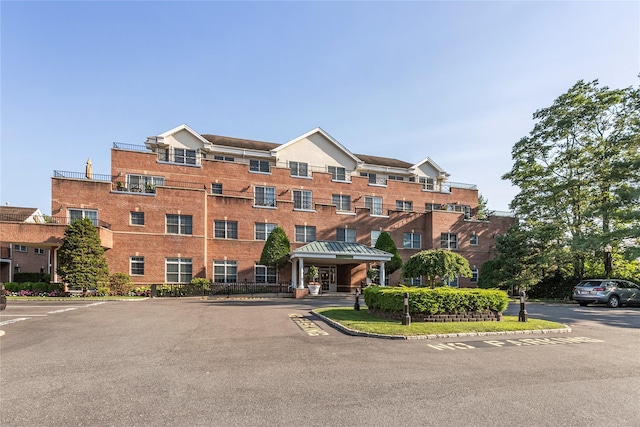 1 Portico Ct Unit 200, Great Neck, NY 11021 - view of building exterior with uncovered parking