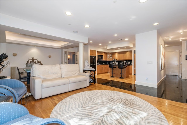 1 Portico Ct Unit 200, Great Neck, NY 11021 - living room with light wood-style floors, recessed lighting, and a tray ceiling