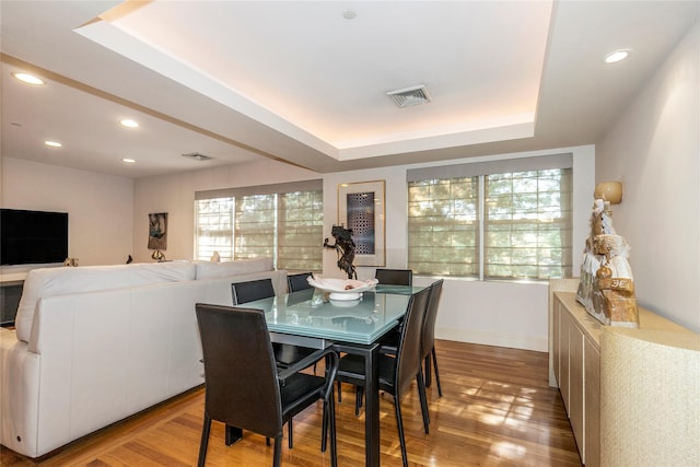 1 Portico Ct Unit 200, Great Neck, NY 11021 - dining space featuring wood finished floors, a raised ceiling, and recessed lighting