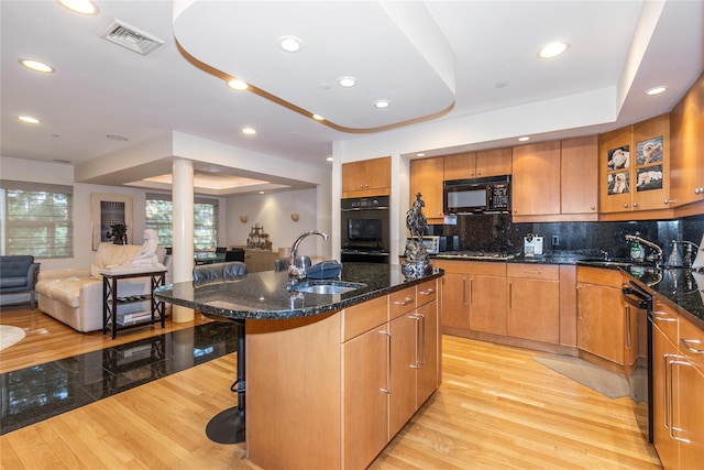 1 Portico Ct Unit 200, Great Neck, NY 11021 - kitchen featuring black appliances, a kitchen breakfast bar, light wood-type flooring, open floor plan, and recessed lighting