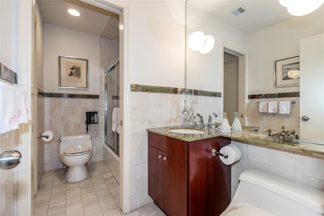 1 Portico Ct Unit 200, Great Neck, NY 11021 - full bath featuring tile walls, tile patterned floors, vanity, shower / bath combination with glass door, and a wainscoted wall