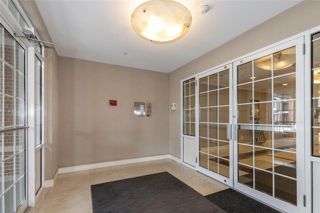 1 Portico Ct Unit 200, Great Neck, NY 11021 - entryway with light tile patterned floors and baseboards