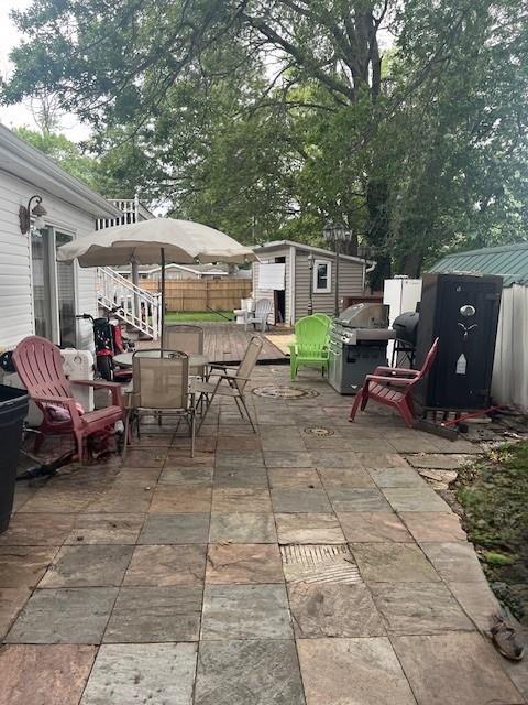 226 14th Ave, West Babylon, NY 11704 - view of patio / terrace with a storage shed, outdoor dining space, and area for grilling