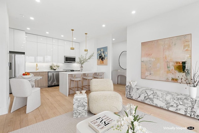 45-29 47th St Unit 3A, Woodside, NY 11377 - living room featuring light wood-style flooring and recessed lighting