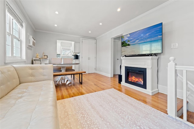 64-41 Springfield Blvd Unit B, Bayside, NY 11364 - living room featuring wood finished floors, recessed lighting, crown molding, a glass covered fireplace, and a wall mounted air conditioner