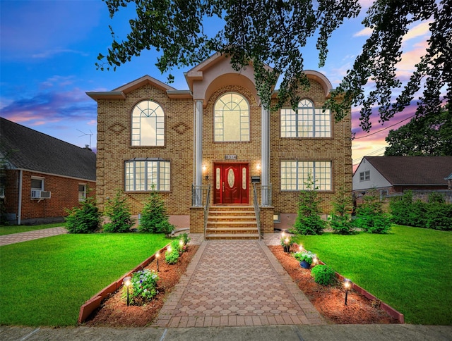 83-14 266th St, Glen Oaks, NY 11004 - view of front of home with brick siding, a lawn, and cooling unit