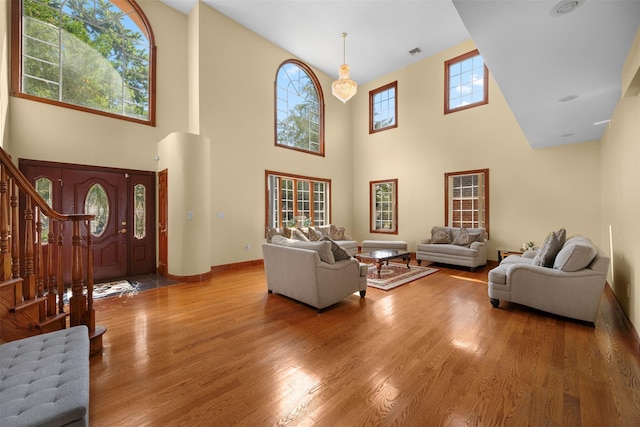 83-14 266th St, Glen Oaks, NY 11004 - living area with a high ceiling, stairs, and wood finished floors