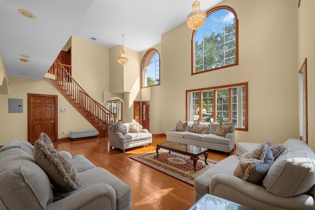 83-14 266th St, Glen Oaks, NY 11004 - living room featuring stairs, wood finished floors, a towering ceiling, and arched walkways