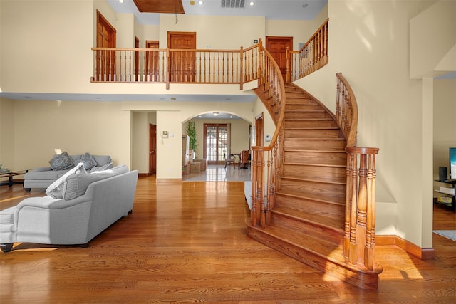 83-14 266th St, Glen Oaks, NY 11004 - stairway featuring arched walkways, wood finished floors, recessed lighting, and a towering ceiling