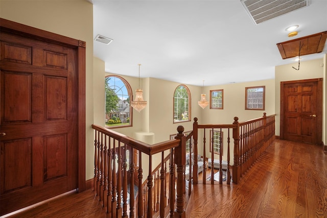 83-14 266th St, Glen Oaks, NY 11004 - hallway featuring an upstairs landing, attic access, wood finished floors, and plenty of natural light