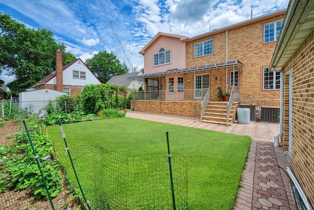 83-14 266th St, Glen Oaks, NY 11004 - back of house with brick siding and a patio area