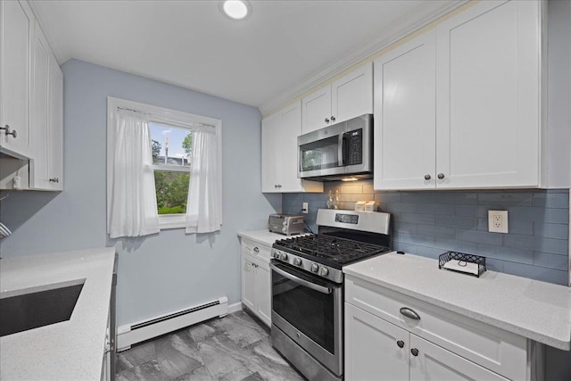 1690 Grand Ave Unit A16, Baldwin, NY 11510 - kitchen with appliances with stainless steel finishes, a baseboard heating unit, white cabinets, and tasteful backsplash