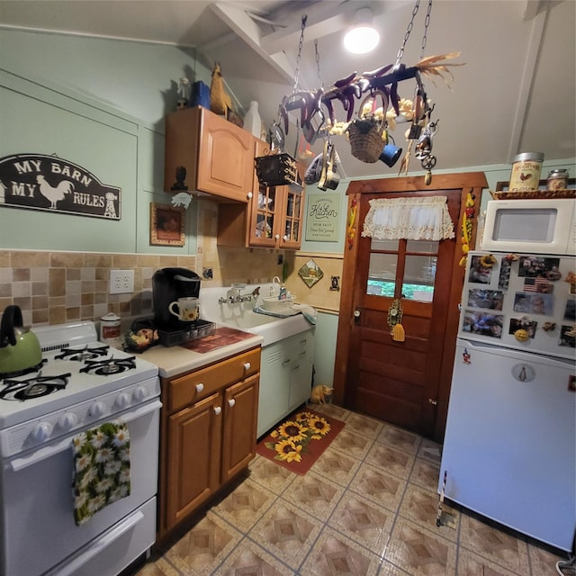 28 E Sullivan Pl, Smallwood, NY 12720 - kitchen with white appliances, backsplash, light countertops, glass insert cabinets, and vaulted ceiling