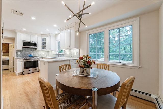 43 Woodglen Dr, New City, NY 10956 - dining room featuring light wood-type flooring, a chandelier, a baseboard heating unit, and recessed lighting