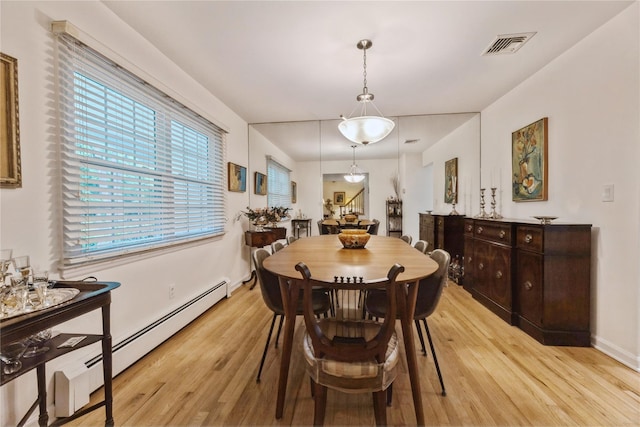43 Woodglen Dr, New City, NY 10956 - dining room with light wood finished floors and a baseboard heating unit