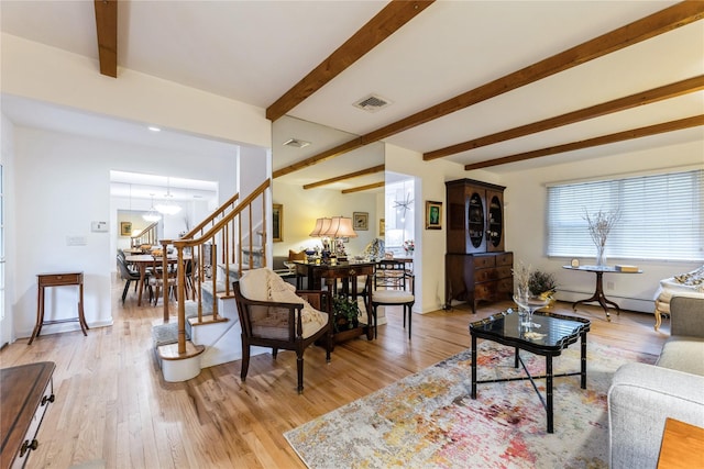 43 Woodglen Dr, New City, NY 10956 - living area featuring beamed ceiling, a chandelier, light wood-type flooring, baseboard heating, and stairway