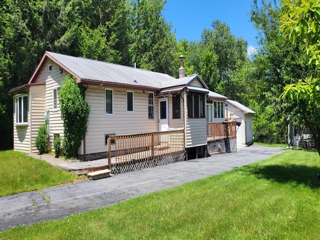 139 Haddock Rd, Monticello, NY 12701 - ranch-style home featuring a front lawn and a wooden deck