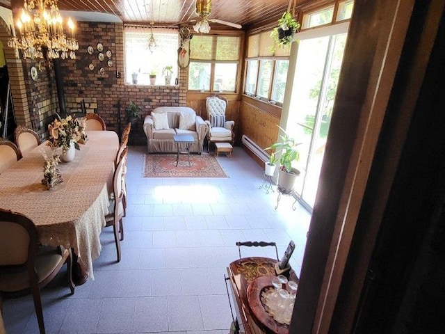 139 Haddock Rd, Monticello, NY 12701 - sunroom / solarium with wooden ceiling, a chandelier, brick wall, and a wood stove