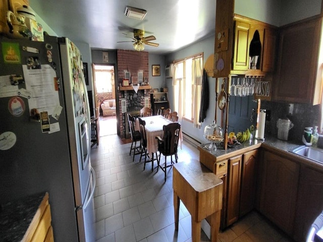 139 Haddock Rd, Monticello, NY 12701 - kitchen with stainless steel fridge, ceiling fan, tile patterned flooring, decorative backsplash, and a peninsula