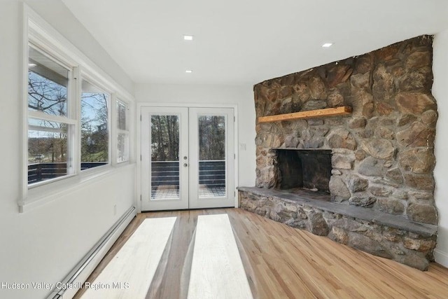 1601 Rte 199, Red Hook, NY 12571 - unfurnished living room with french doors, wood finished floors, baseboard heating, and a fireplace