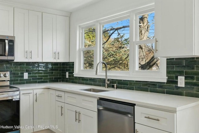1601 Rte 199, Red Hook, NY 12571 - kitchen featuring stainless steel appliances, white cabinets, tasteful backsplash, and light countertops
