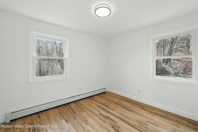 1601 Rte 199, Red Hook, NY 12571 - empty room featuring baseboard heating, plenty of natural light, and light wood finished floors