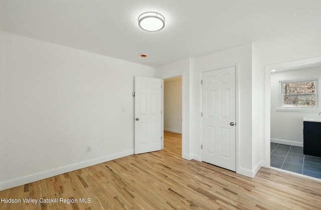 1601 Rte 199, Red Hook, NY 12571 - unfurnished bedroom featuring wood finished floors and baseboards