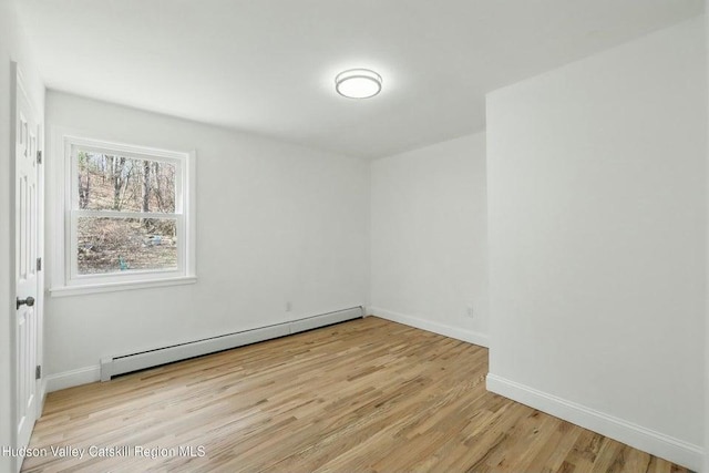 1601 Rte 199, Red Hook, NY 12571 - unfurnished room featuring a baseboard heating unit and wood finished floors
