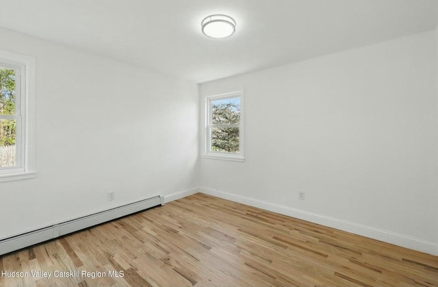 1601 Rte 199, Red Hook, NY 12571 - empty room featuring a baseboard radiator, healthy amount of natural light, and light wood-style floors