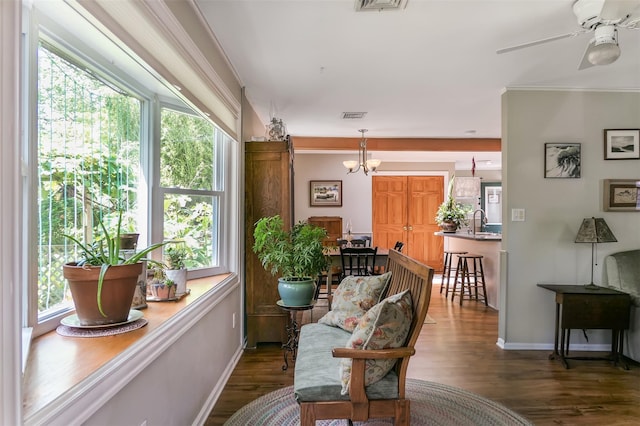 7 Clover Ln, Brookhaven, NY 11719 - living area featuring wood finished floors, a ceiling fan, crown molding, and a chandelier