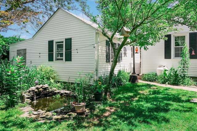 7 Clover Ln, Brookhaven, NY 11719 - view of property exterior featuring a lawn
