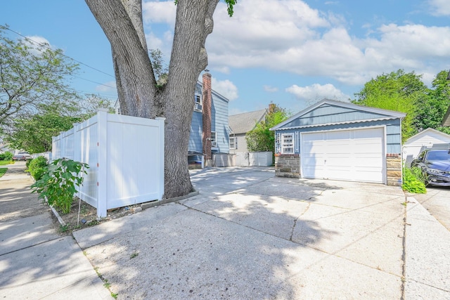 118 Edmund, Lynbrook, NY 11563 - view of side of home with driveway, an outbuilding, and stone siding