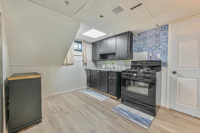 118 Edmund, Lynbrook, NY 11563 - kitchen featuring gas stove, light wood-type flooring, light countertops, and dark cabinetry