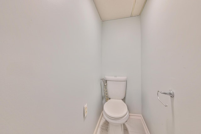 118 Edmund, Lynbrook, NY 11563 - bathroom featuring toilet and marble look tiles