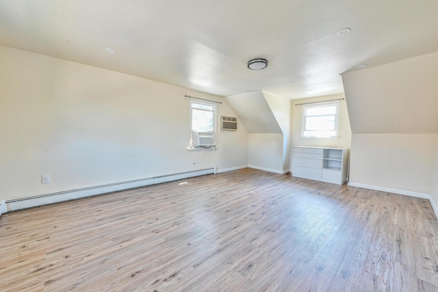 118 Edmund, Lynbrook, NY 11563 - additional living space with baseboard heating, wood finished floors, plenty of natural light, vaulted ceiling, and cooling unit