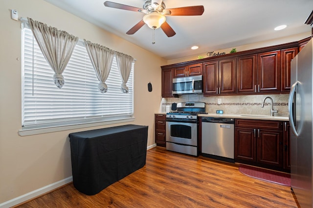 81 Baldwin Rd, Hempstead, NY 11550 - kitchen featuring appliances with stainless steel finishes, light countertops, dark wood-style flooring, decorative backsplash, and a ceiling fan