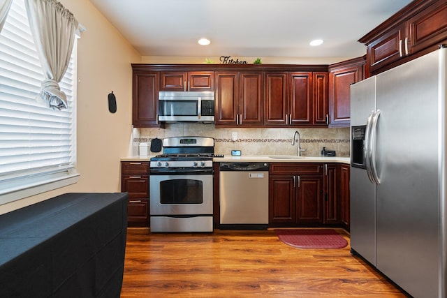 81 Baldwin Rd, Hempstead, NY 11550 - kitchen featuring stainless steel appliances, light countertops, decorative backsplash, wood finished floors, and recessed lighting
