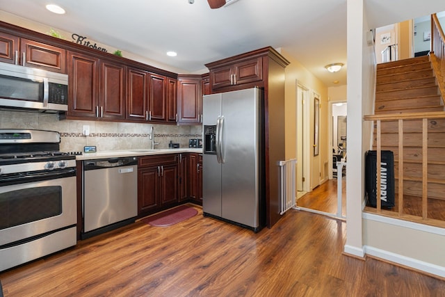 81 Baldwin Rd, Hempstead, NY 11550 - kitchen with stainless steel appliances, dark wood-style floors, decorative backsplash, light countertops, and recessed lighting