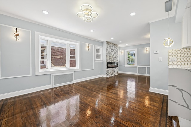 73 Broadway, Valley Stream, NY 11580 - unfurnished living room with wood finished floors, a fireplace, and ornamental molding
