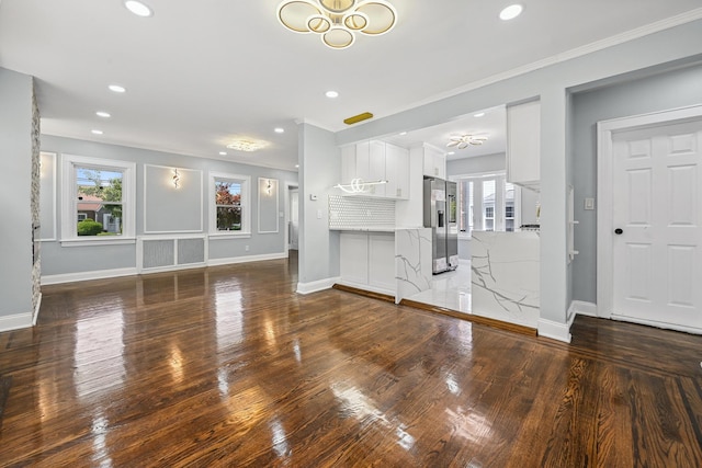73 Broadway, Valley Stream, NY 11580 - unfurnished living room featuring recessed lighting, wood finished floors, crown molding, and a chandelier