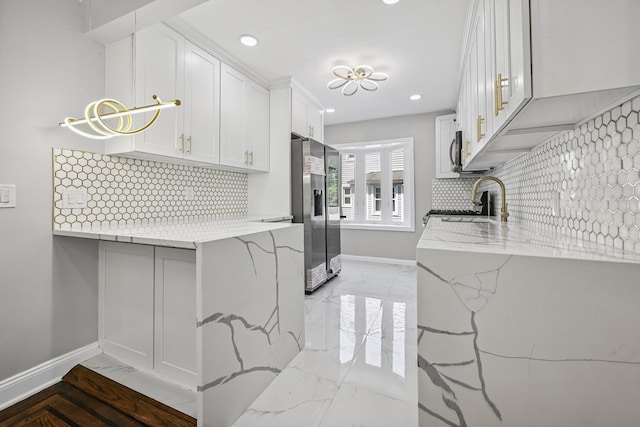 73 Broadway, Valley Stream, NY 11580 - kitchen featuring appliances with stainless steel finishes, light marble finish floors, light stone counters, decorative backsplash, and recessed lighting