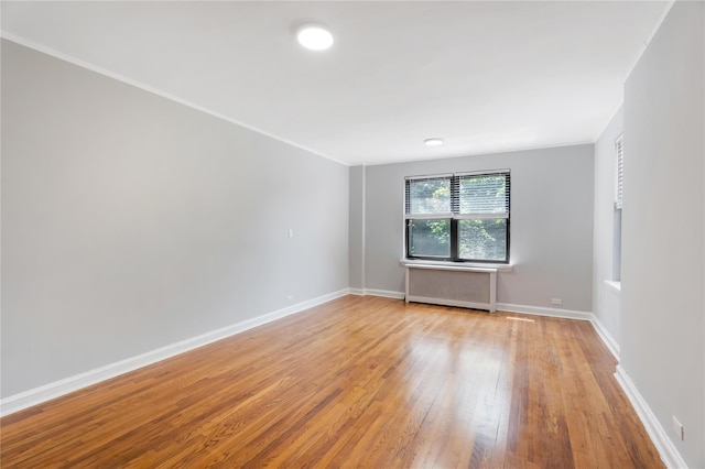 84-39 153rd Ave Unit 1K, Flushing, NY 11414 - unfurnished room with radiator and light wood finished floors