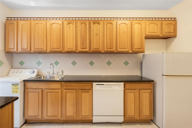 84-39 153rd Ave Unit 1K, Flushing, NY 11414 - kitchen featuring white appliances, washer / clothes dryer, decorative backsplash, dark stone countertops, and light tile patterned flooring