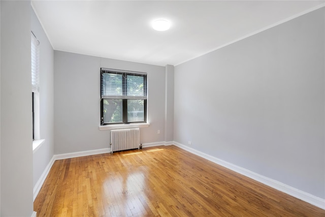 84-39 153rd Ave Unit 1K, Flushing, NY 11414 - spare room with radiator heating unit and light wood-style floors