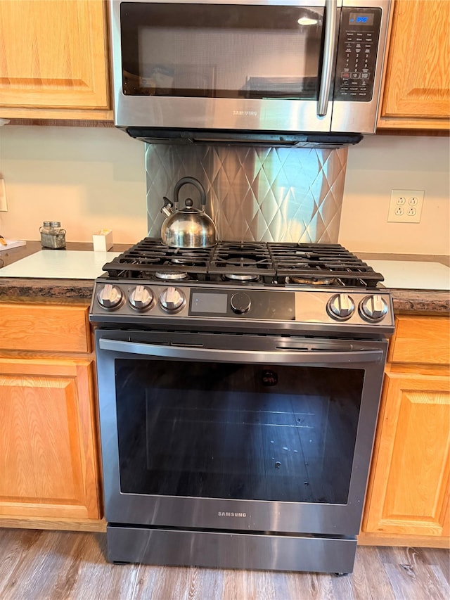 69 Finkle Rd, Summitville, NY 12790 - kitchen with appliances with stainless steel finishes, light brown cabinets, wood finished floors, and backsplash